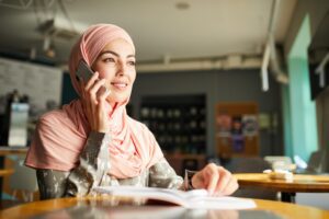 Muslim woman on the phone. Making a follow up call to Recruitment agency/Hiring manager