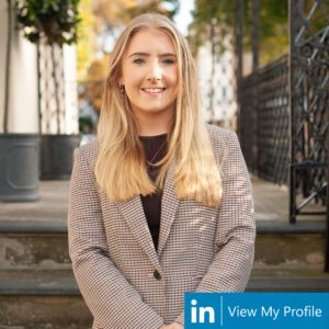 Sophie, Recruitment consultant for Healthcare and Education division at Hooray Recruitment poses outside Hooray HQ in Cheltenham.