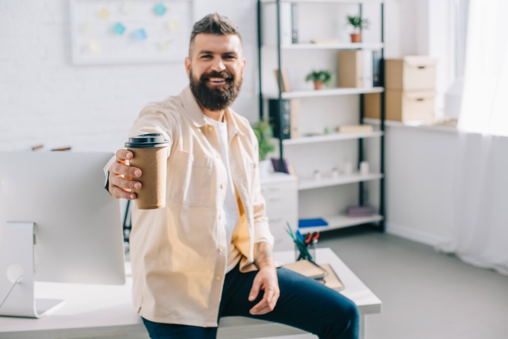 Happy manager with coffee offered to Employee. Breaks are important for productivity! 