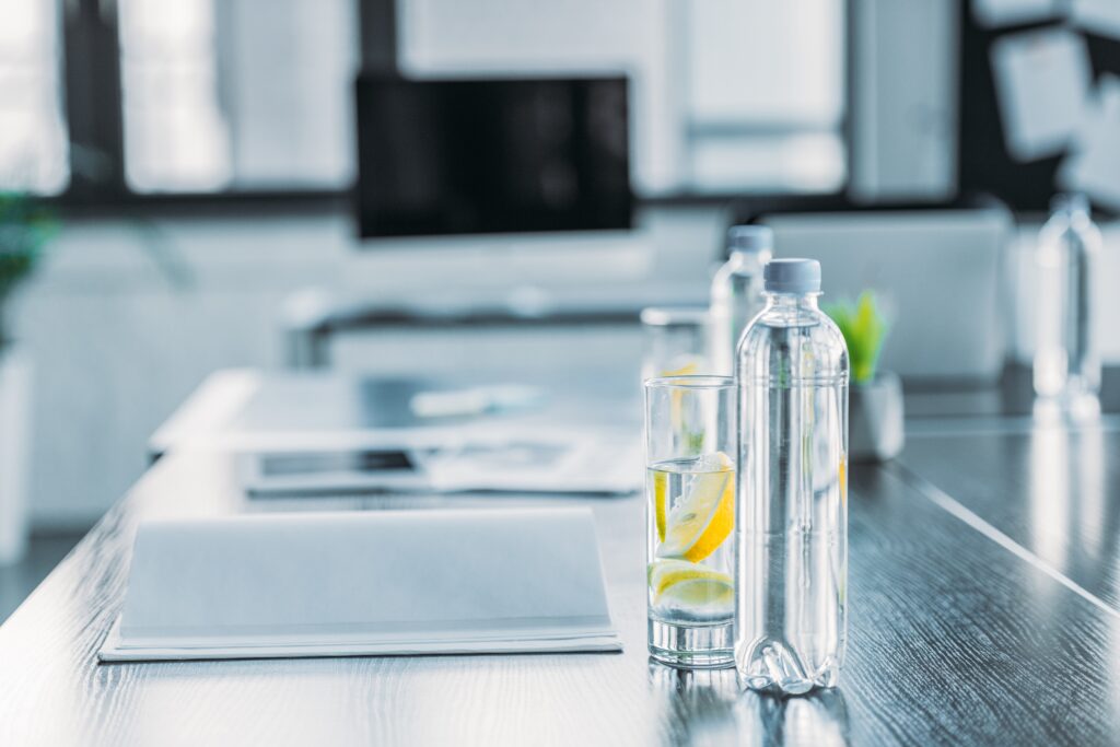 Glass of water to promote hydration and productivity, part of healthy lifestyle tips for office professionals