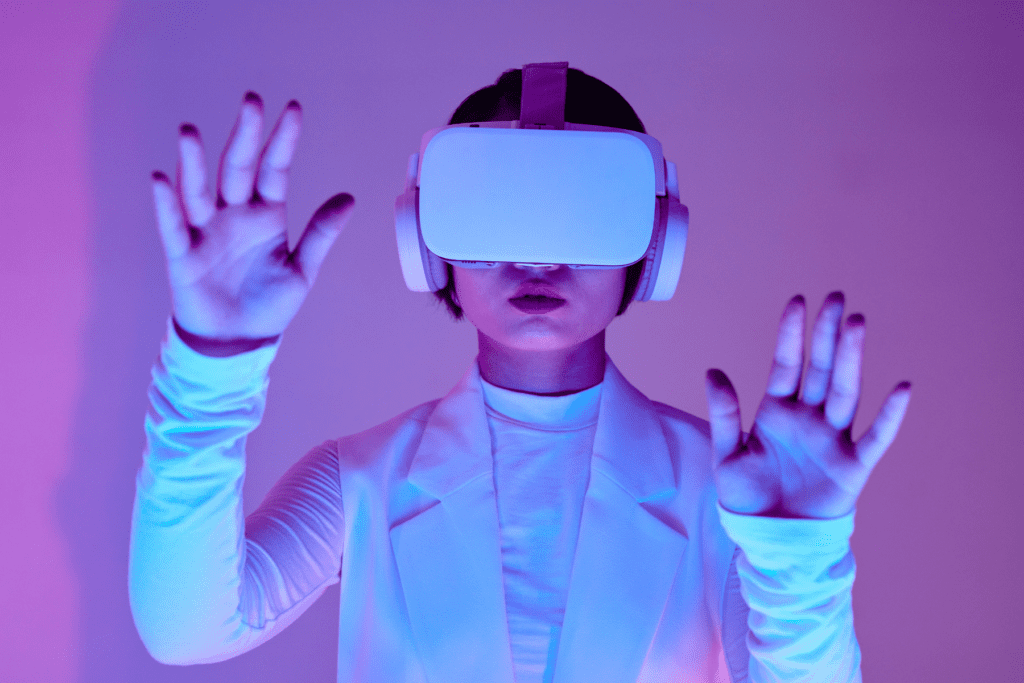 A woman wearing a virtual reality headset, symbolising the use of immersive technology in learning and development initiatives, a key trend in recruitment for 2025.